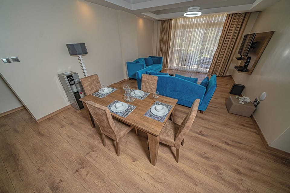 Deluxe Apartment, City View | Living area | 64-inch Smart TV with digital channels