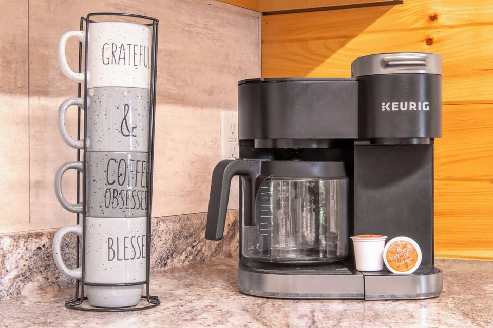 Your morning coffee awaits with a convenient Keurig machine and cheerful mugs, ready to start your day right in your home-away-from-home.