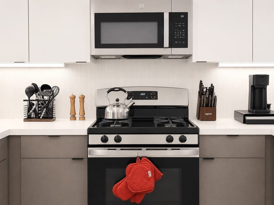 Experience extended comfort with a fully equipped kitchen featuring a coffee machine, stovetop, and microwave—everything you need for a seamless long-term stay.