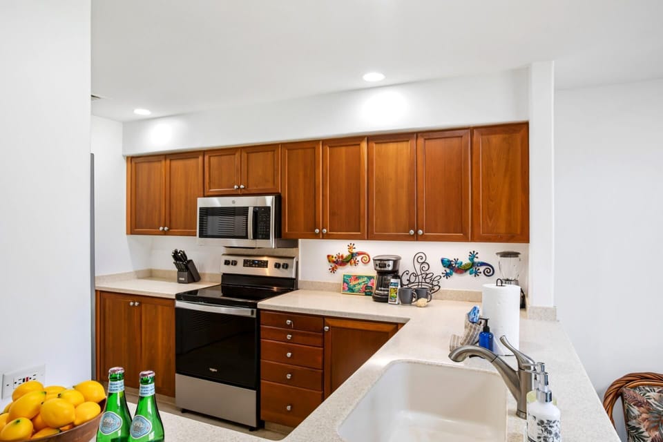 Smooth counters, gleaming appliances, and coconut-colored cabinets make this space a chef’s island daydream    