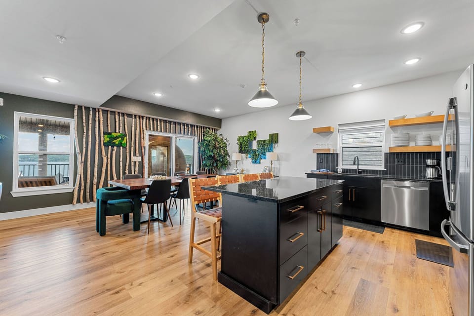 Cook, dine, and make memories in this open kitchen featuring a spacious table that fits the whole group comfortably.