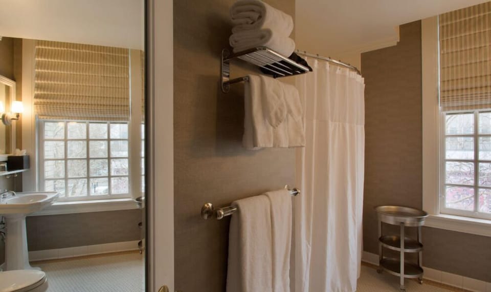 Enjoy a spacious shower in this well-equipped bathroom, featuring up-to-date fixtures and excellent lighting.