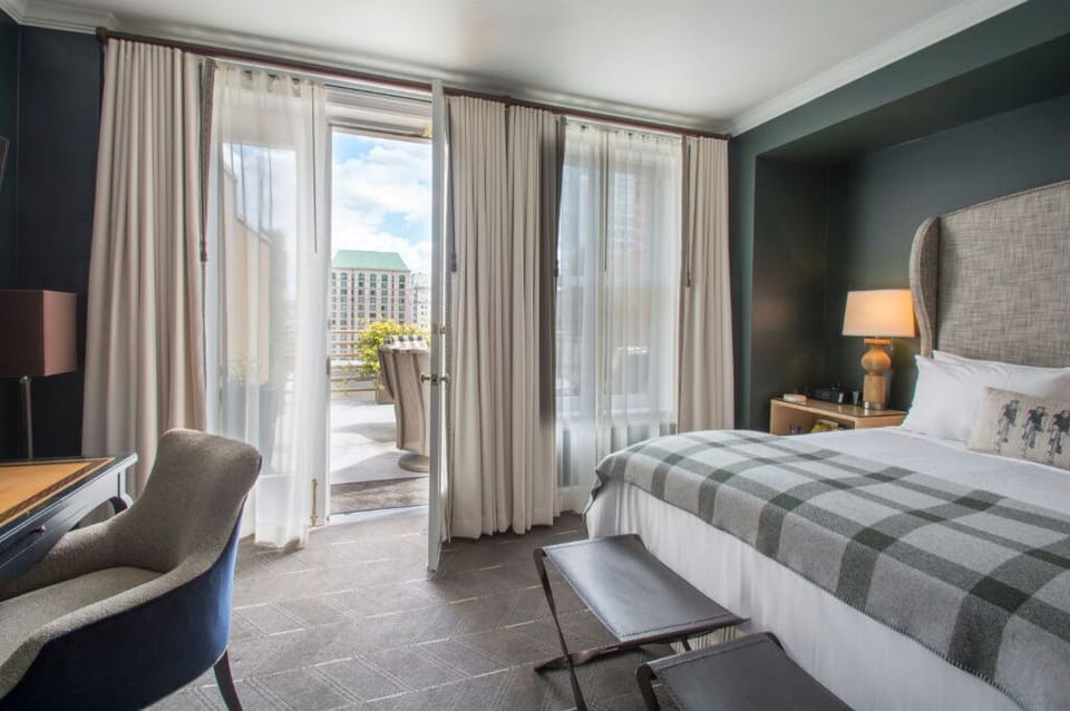 Experience comfort and style in this well-appointed bedroom with a plush bed, large windows, and tasteful furnishings.