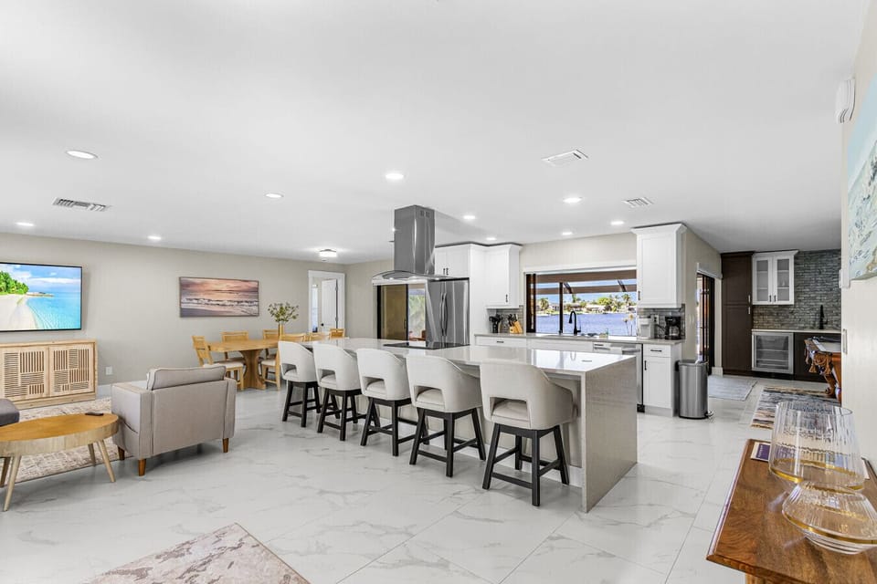 Spacious chef`s kitchen perfect for group meals, featuring modern appliances and an open layout that flows to the dining area.