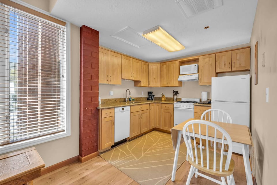 The kitchen makes efficient use of the space with a range of appliances, ample space for storing your food items, and an eating area.
