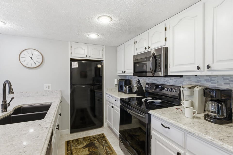  Whip up culinary delights in this stylish kitchen with modern appliances and elegant decor!