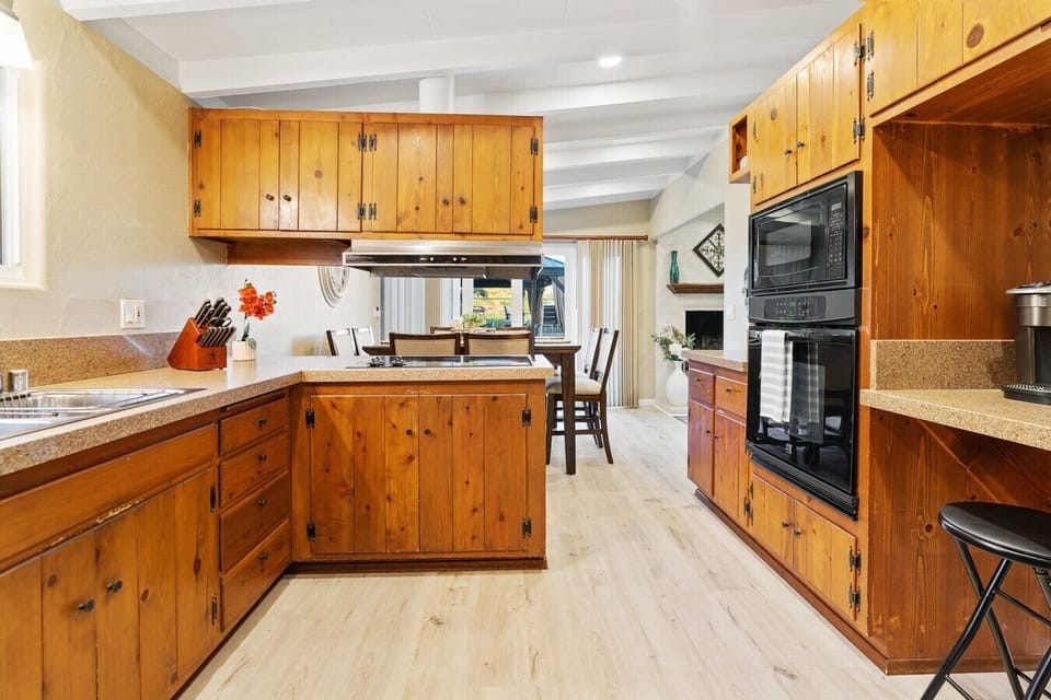 Classic wood cabinetry and an eat-in peninsula make this kitchen both functional and full of character.