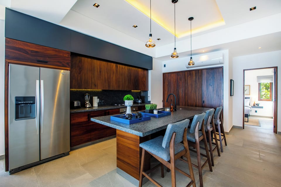 The sleek kitchen is fully-equipped