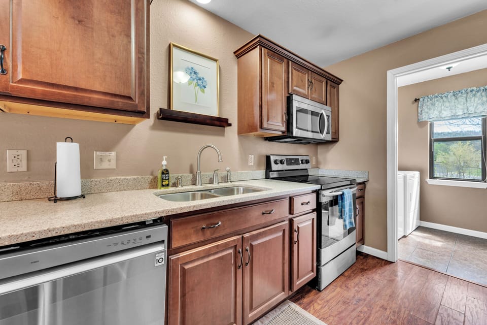 Large and modern kitchen well stocked with necessities to do meal prep. 