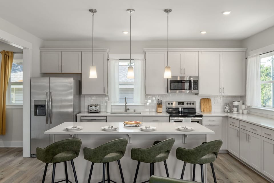 Spacious kitchen with kitchen island and bar seating for 4