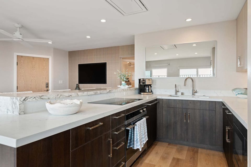 Kitchen view with all appliances and living room view.