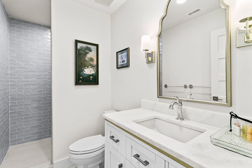 Guest bathroom off the hall with a walk in shower.