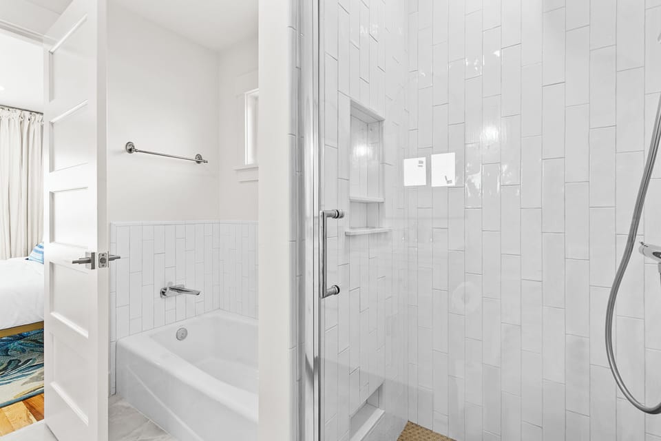 The bathroom off the primary bedroom has both a walk-in shower and a soaking tub for a spa-like experience.