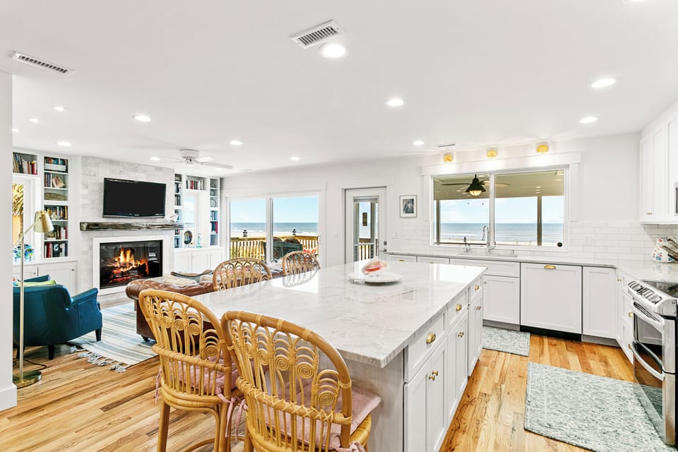 Open concept kitchen and living space with bar seating for four.