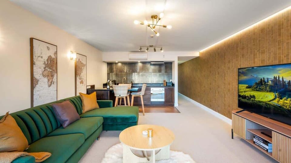 Soak up the Queenstown views from the living room, featuring chic furnishings and an airy, open-plan design.