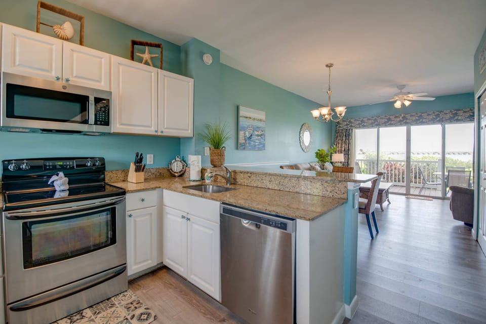 The updated kitchen at Water View Keys Retreat boasts sleek stainless steel appliances and elegant granite countertops, perfect for preparing meals.