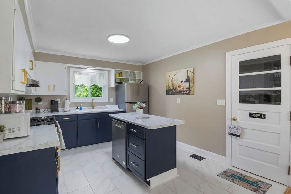 Delight in this spacious, modern kitchen featuring a large central island and sleek finishes, perfect for culinary creations and social gatherings.