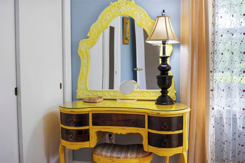 Add a touch of vintage charm with this elegant vanity, featuring intricate detailing and a bright yellow finish, perfect for morning routines and evening prep.