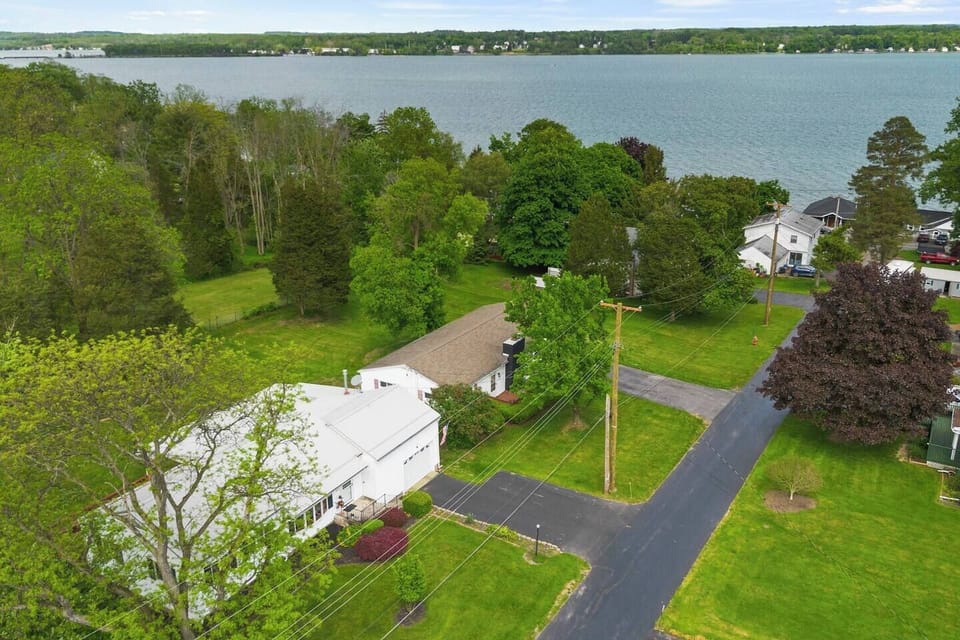 Charming single-story home with a spacious driveway, attached garage, and lush greenery. Perfect for enjoying a peaceful suburban lifestyle in a cozy and inviting setting.