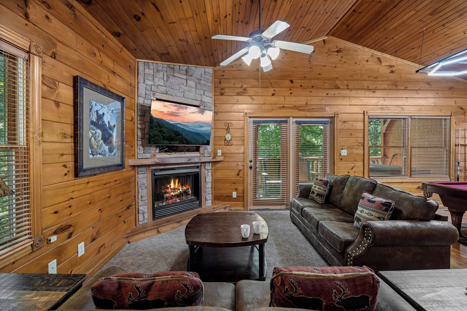 Spacious living room with TV, sleeper sofa, and fireplace