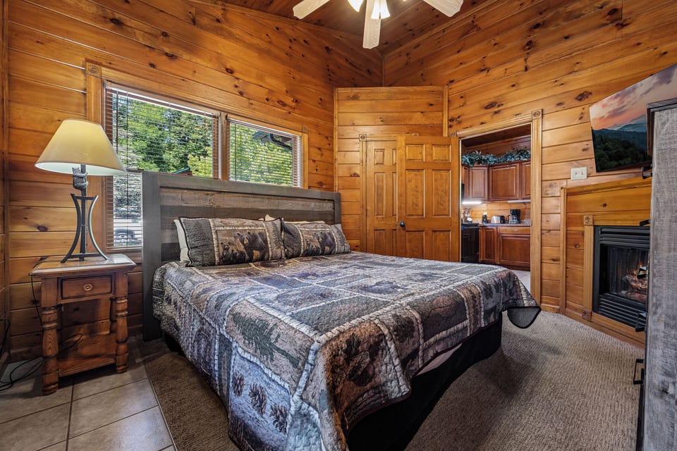 King bedroom with TV, fireplace, & heart shaped jacuzzi tub.