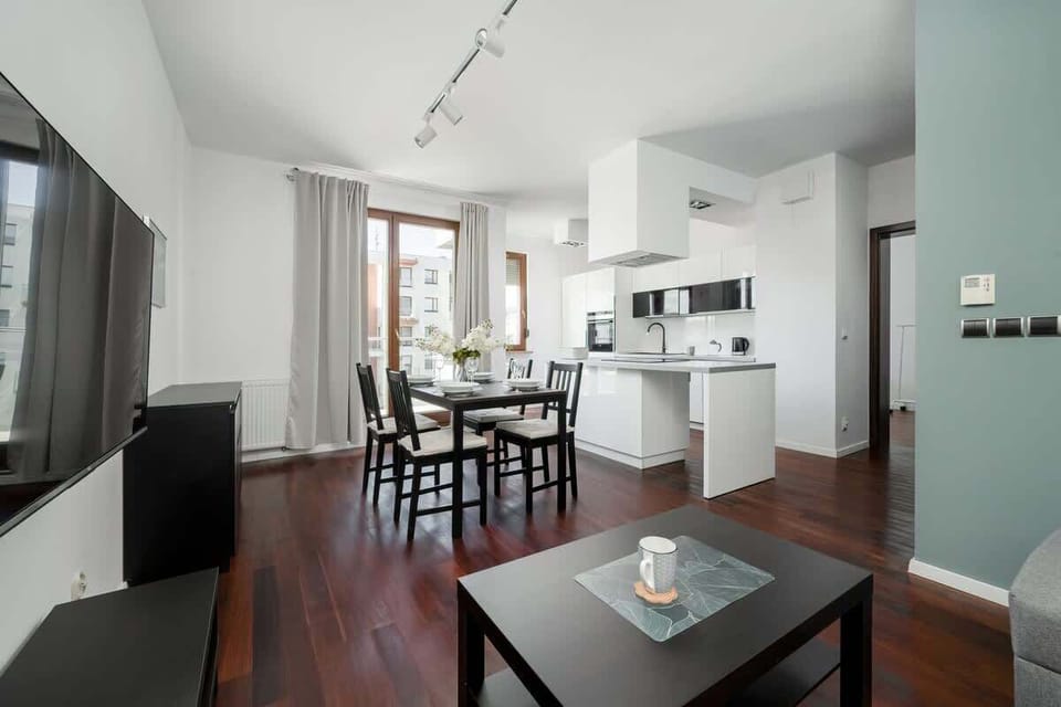 The open-plan living space filled with natural light offers a seamless experience of cooking, dining, and relaxing.