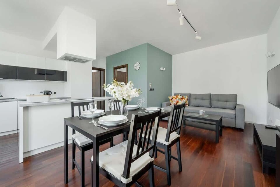 The bright dining area with an elegant table and floral decor is perfect for shared meals and wine-filled conversations.
