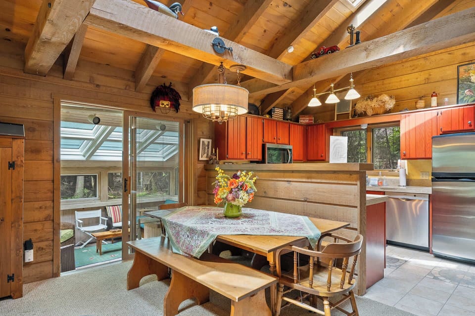 Dining table offers seating for 6 and opens to the sunroom