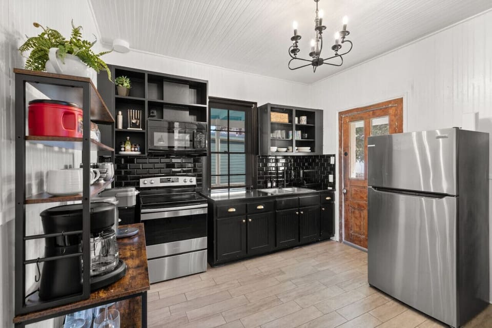 Modern black kitchen, fully stocked and ready.