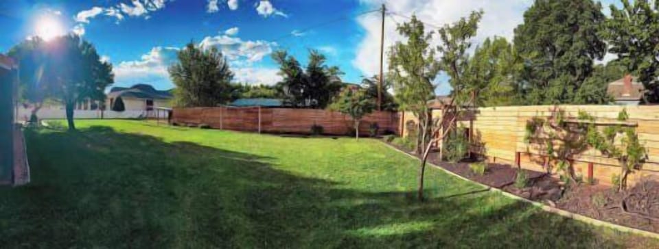 Enjoy the expansive, private backyard at Green Oasis, perfect for relaxation and games under the Kanab sun!