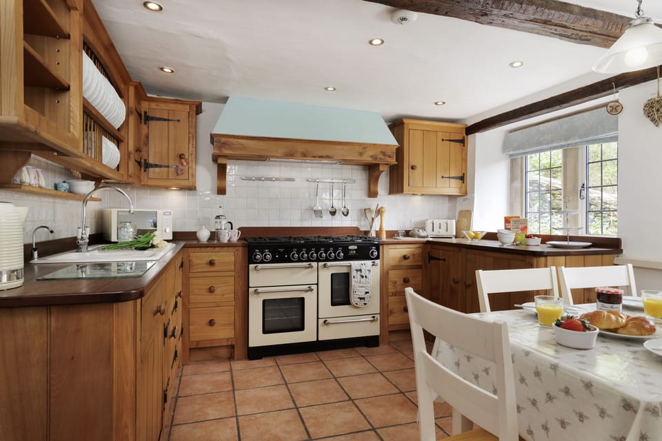 The homely, farmhouse style kitchen/dining room with range oven