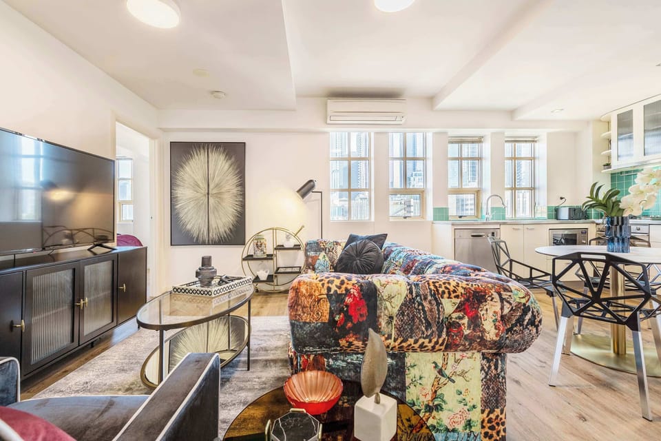 LIVING ROOM: A statement sofa, a mirror fit for a soirée, and views worth raising a glass to. This is the heart of Gatsby.