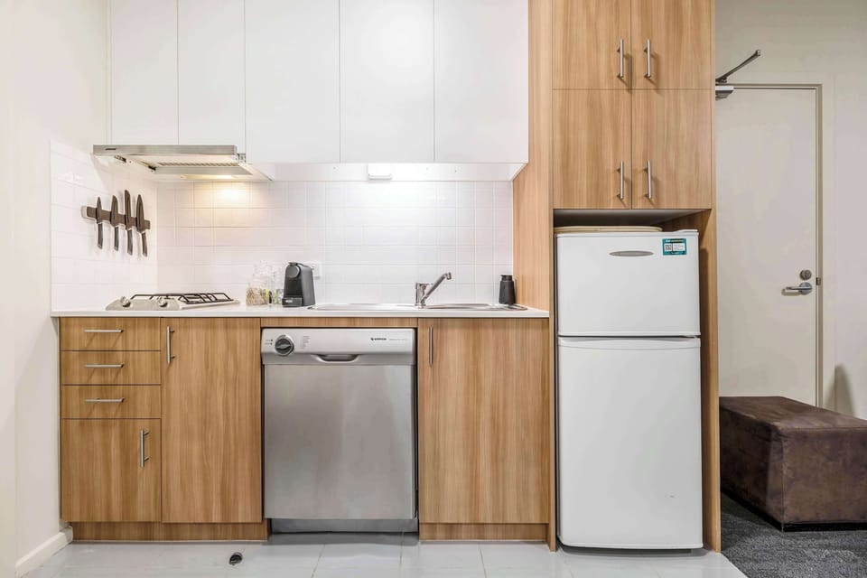 Compact modern kitchen with fridge, stove, and dishwasher for all your cooking needs