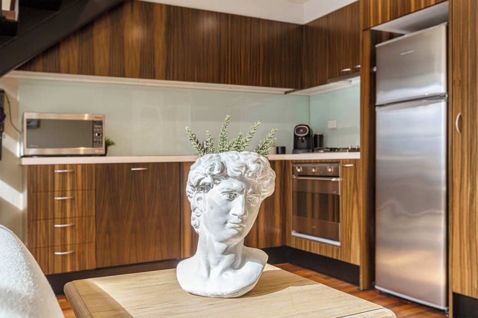 Stylish kitchen accented with warm wood cabinetry and unique décor for a touch of personality