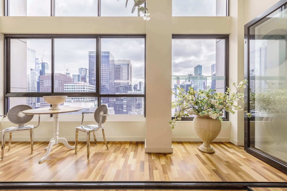 Sunlit dining nook by floor to ceiling windows, enjoy your morning coffee with skyline views