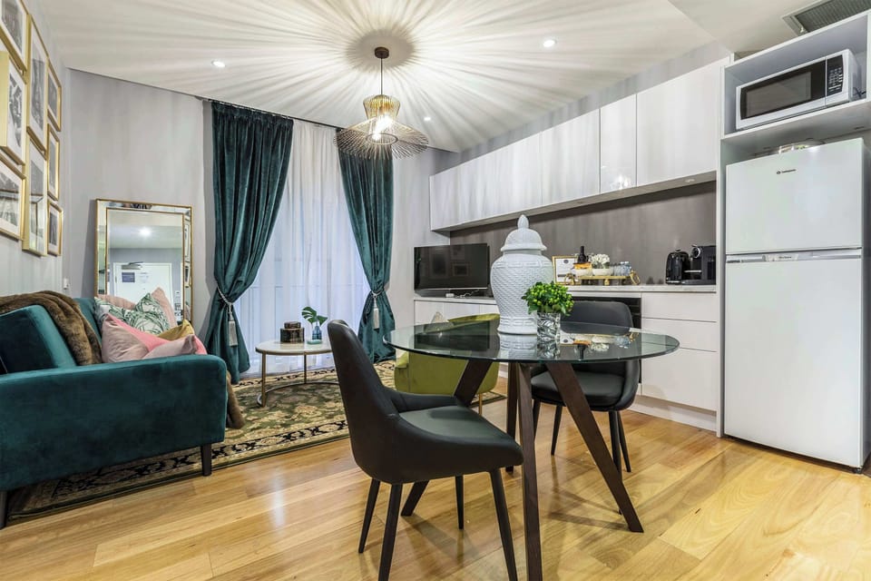 Stylish dining area with a glass table and comfortable seating, seamlessly connected to the cozy living space