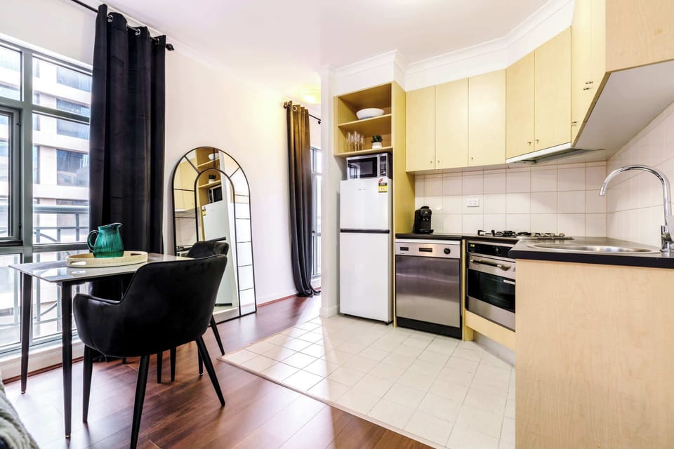 Kitchenette and Dining at Monet: Modern kitchen and dining area with appliances, ample counter space, and a cozy spot to enjoy meals by the window