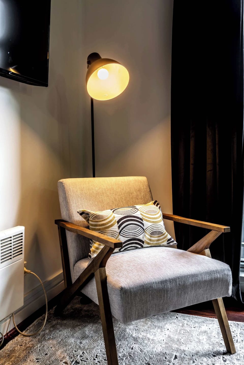 Cozy reading nook with a comfortable armchair, soft lighting, and stylish accents