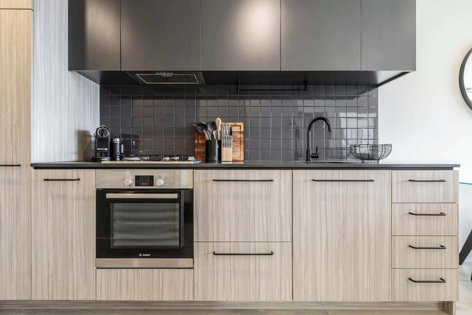 Modern kitchen with sleek cabinetry, quality appliances, and ample bench space