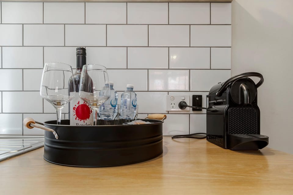 Complimentary welcome tray with wine, glasses, and bottled water, plus a Nespresso coffee machine for your stay