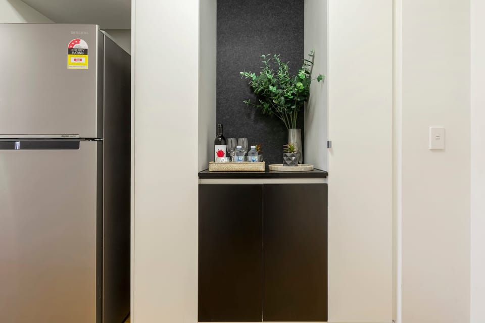Thoughtful welcome nook with wine, water, and greenery to make your stay extra special