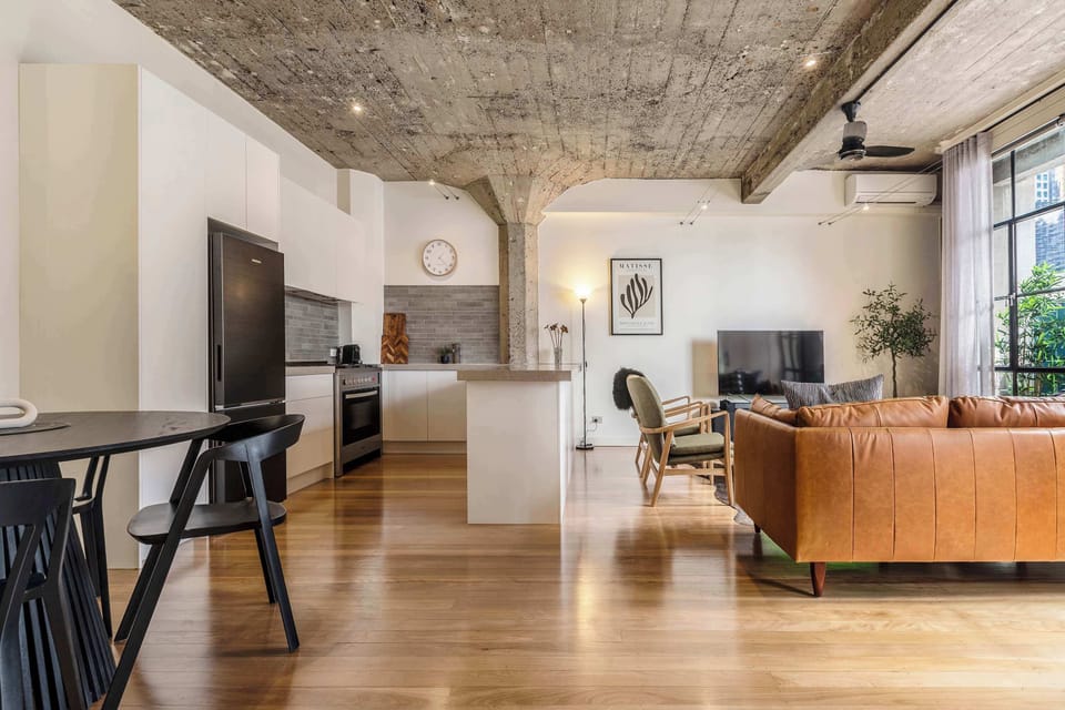 Spacious open plan living with kitchen, dining, and lounge areas seamlessly connected