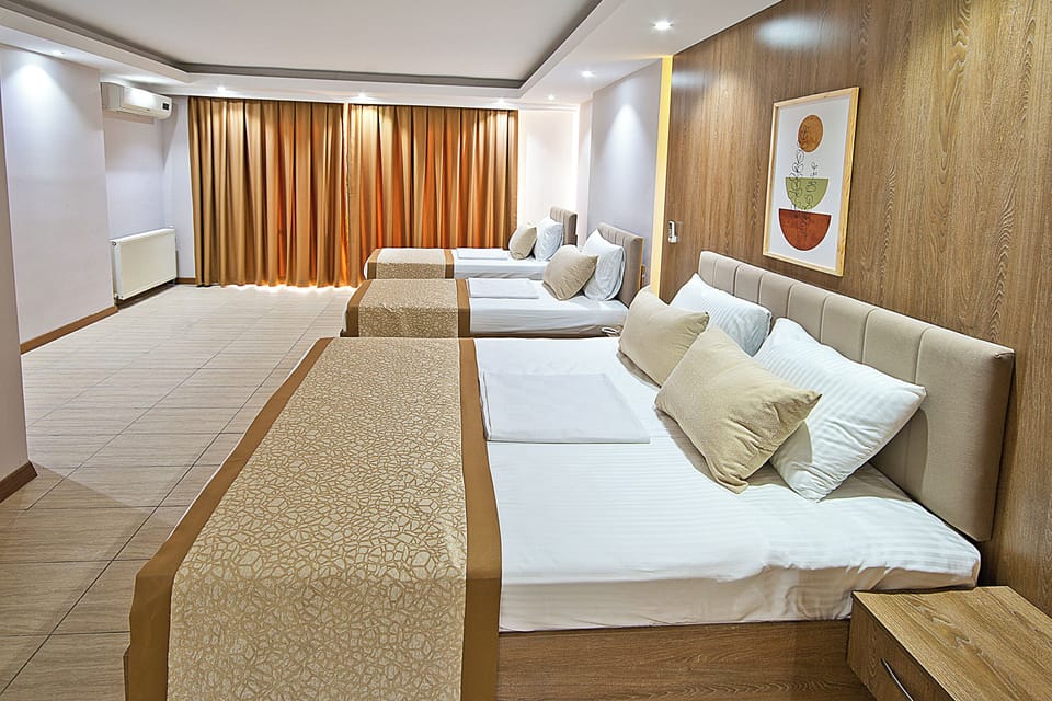Deluxe Quadruple Room | Down comforters, Tempur-Pedic beds, minibar, in-room safe