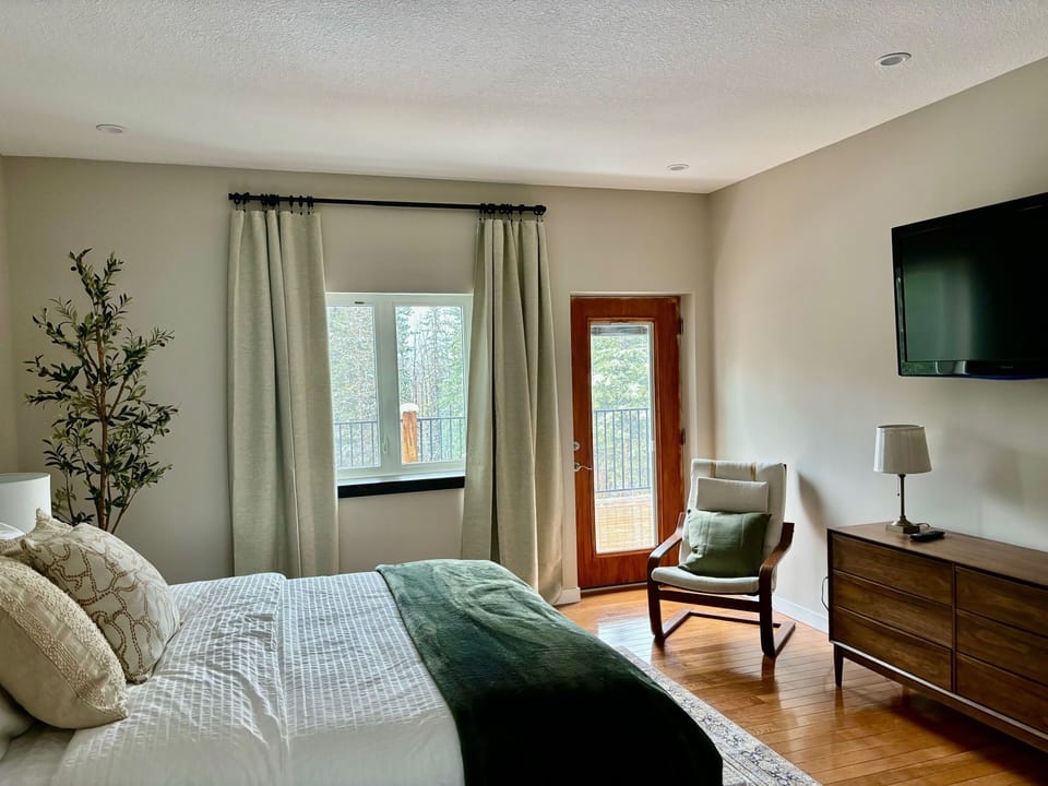 Master bedroom complete with an ensuite and balcony overlooking the backyard.