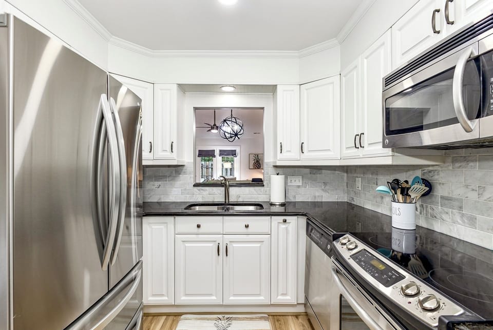 Well equipped kitchen with large fridge.