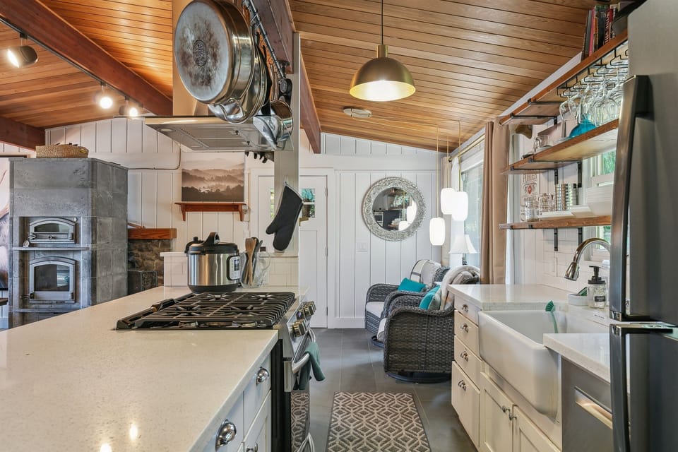 A chef's kitchen delights with a gas range and farmhouse sink, all with a view of the lake!
