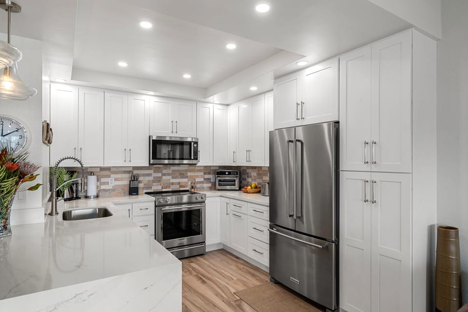 Bright and modern kitchen featuring premium stainless-steel appliances and a clean aesthetic, perfect for cooking and entertaining.