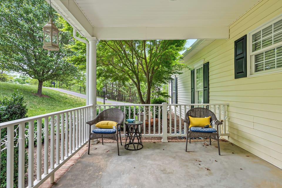 Charming side porch nook with comfortable seating, ideal for peaceful moments