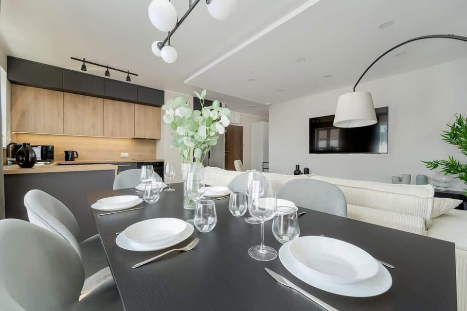 An open kitchen with a dining area combines functionality and modern design, creating a welcoming space for cooking and gathering.