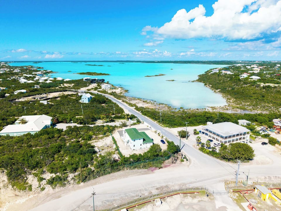 Stunning aerial view of the property with the turquoise waters in the background.